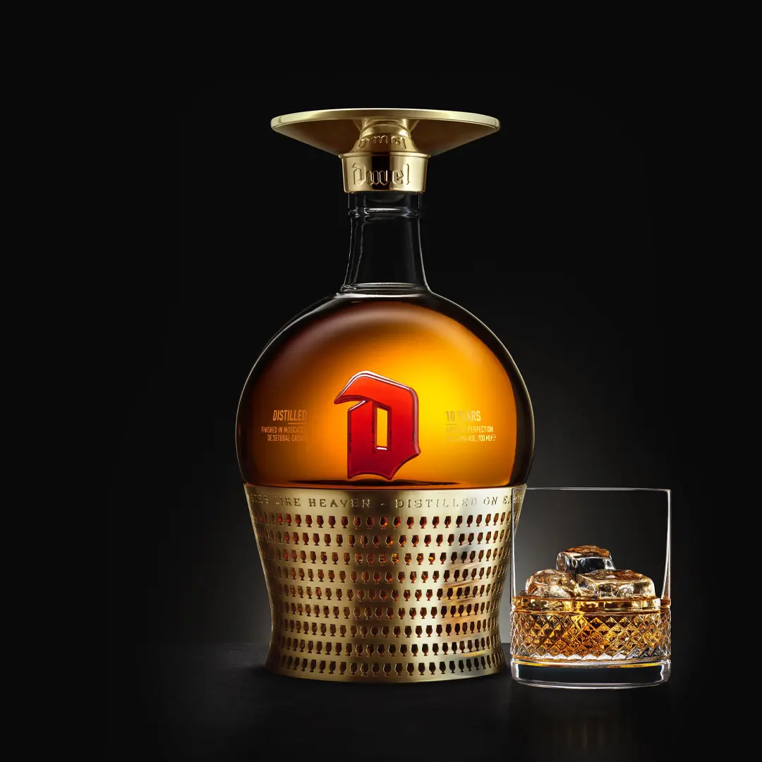 A Duvel distilled 150 years celebration bottle packshot with a glass.